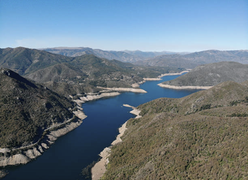 The dark blue Biobío River, winding through the dry foothills of the Andean Valley.