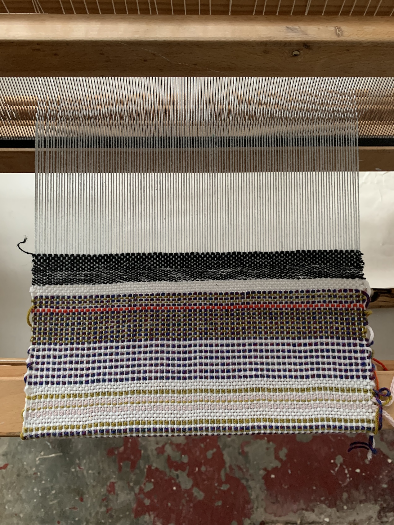 fabric on a loom by Shelby Wilson